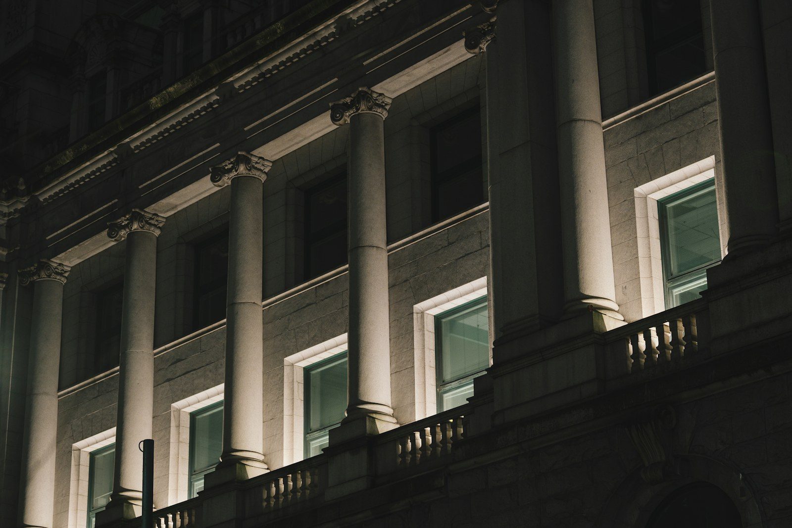 Columns of a civic building lit at night
