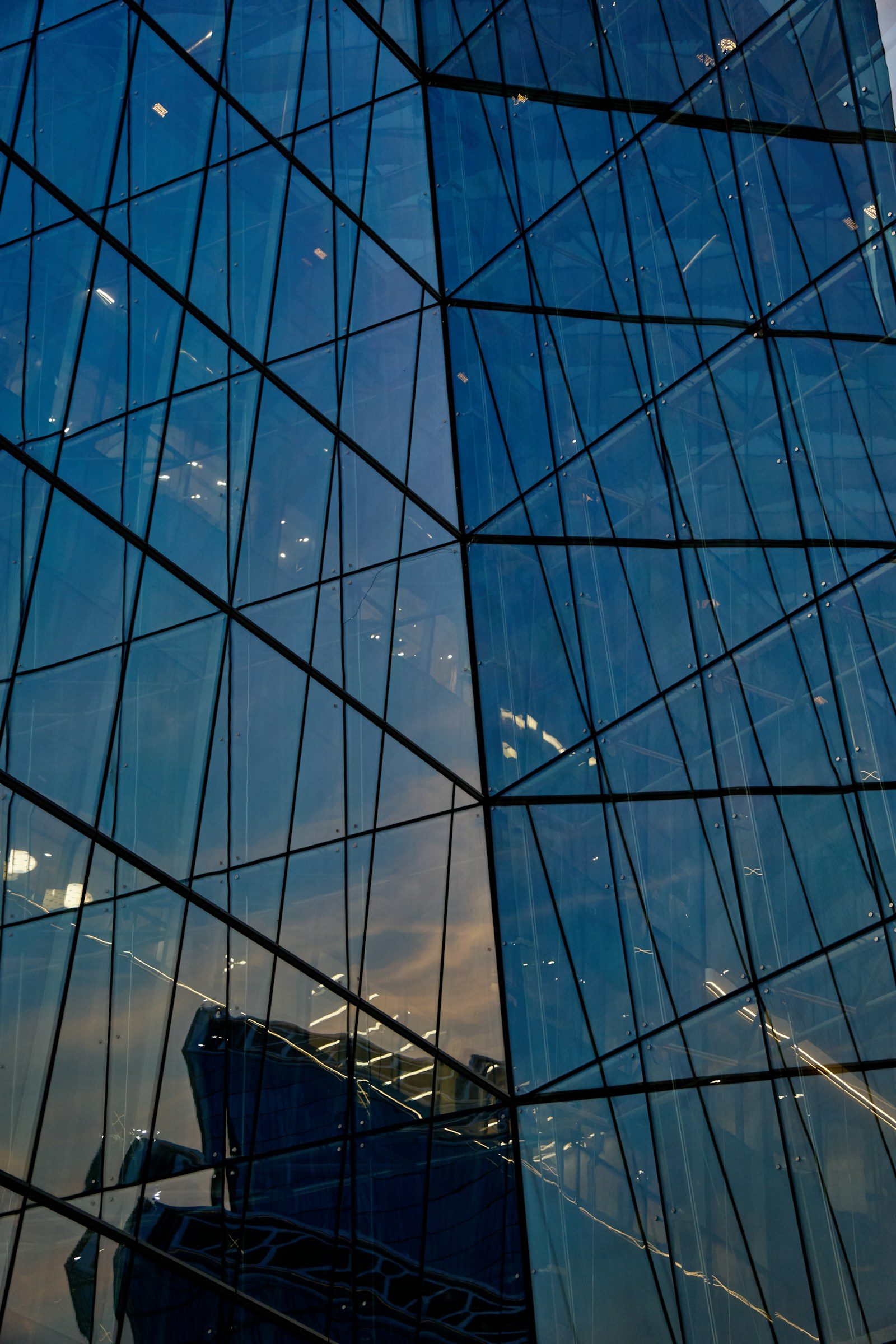 An office tower reflected in the glass of a neighbouring building